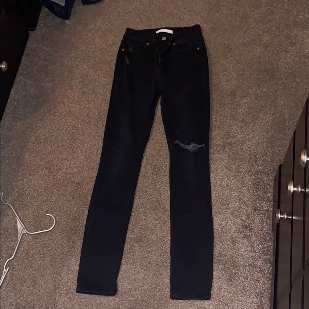 Black jeans hole on one knee.